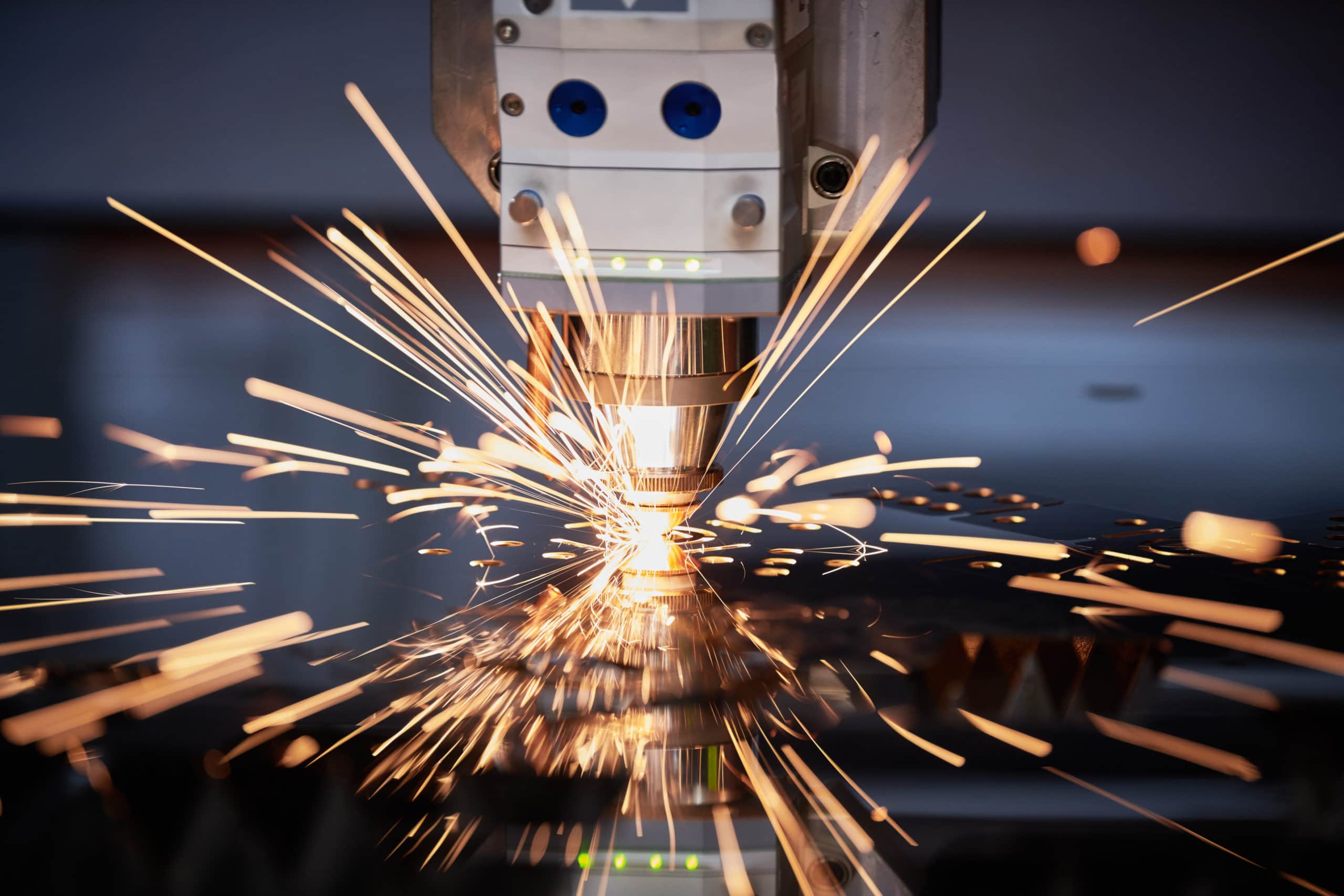 Laser cutting. Metal machining with sparks on CNC laser engraving machine